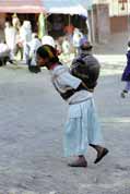 Water carrying from public pipe to house. Lalibela. North,  Ethiopia.