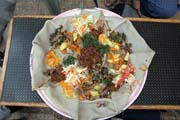 Traditional and common food - injara. Sour pankake served with variety of meet and vegertable. Ethiopia.