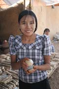 Thanaka - local make-up for ladies. ,All women are whitenig their faces with such kind of parfume which is made from ground bark of thanakha tree. Old Bagan market. Myanmar (Burma).