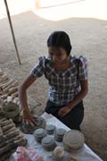 ,All women are whitenig their faces with such kind of local parfume made from ground bark of thanakha tree. Old Bagan market. Myanmar (Burma).