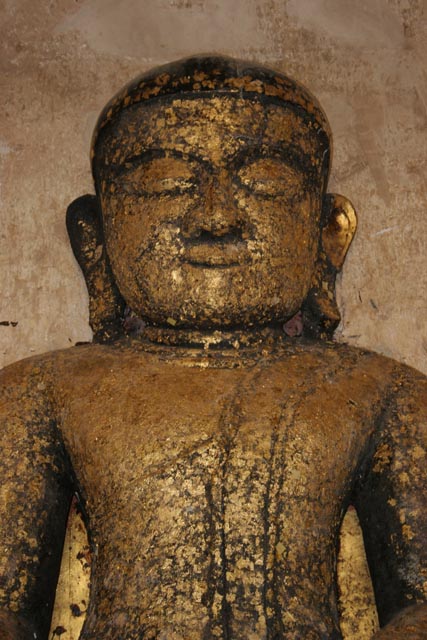 Buddha statues are often decorated by golden papers. Bagan. Myanmar (Burma).